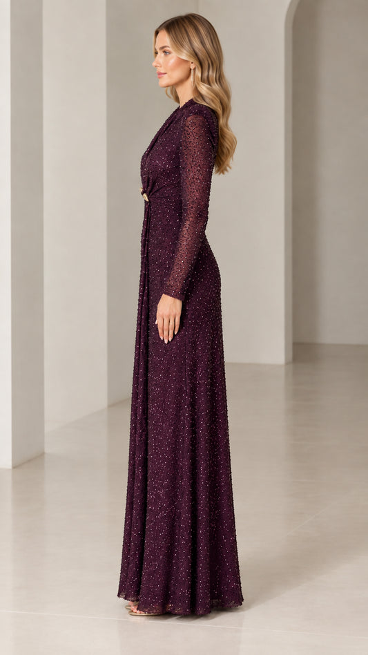 Side profile of burgundy sequin floor-length formal gown with long sleeves