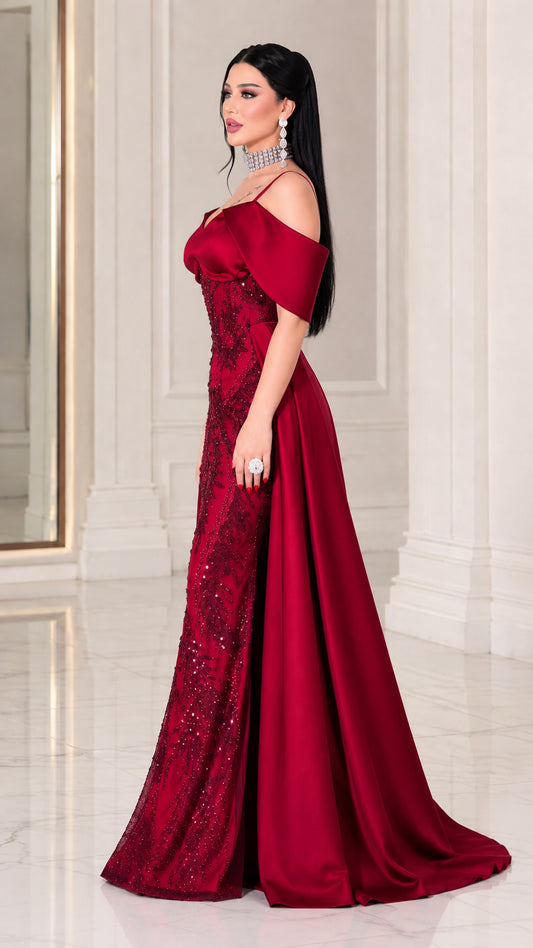 Side angle view of model posing in Wine Red beaded evening gown with sweeping train