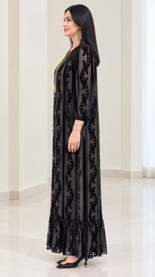 Side profile of black velvet burnout long sleeve maxi dress