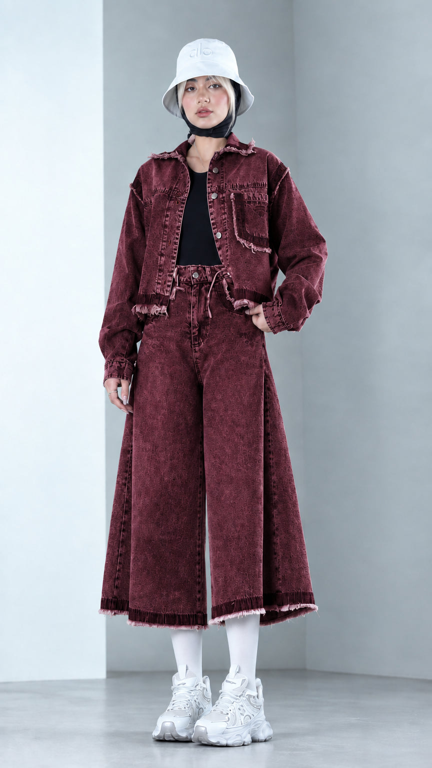 Front view of model wearing Burgundy washed raw hem denim matching set