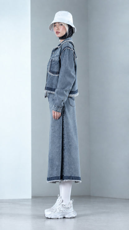 Side profile view of Denim Blue two-piece denim co-ord set with raw fringe hems