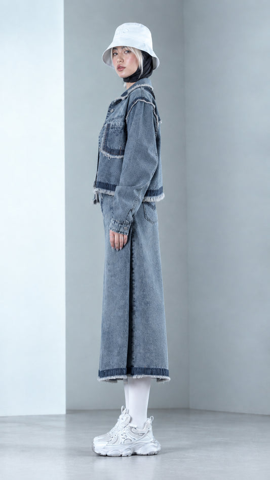 Side profile view of Denim Blue two-piece denim co-ord set with raw fringe hems