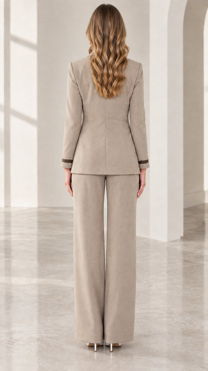 Back view of woman wearing taupe blazer and matching wide-leg trousers