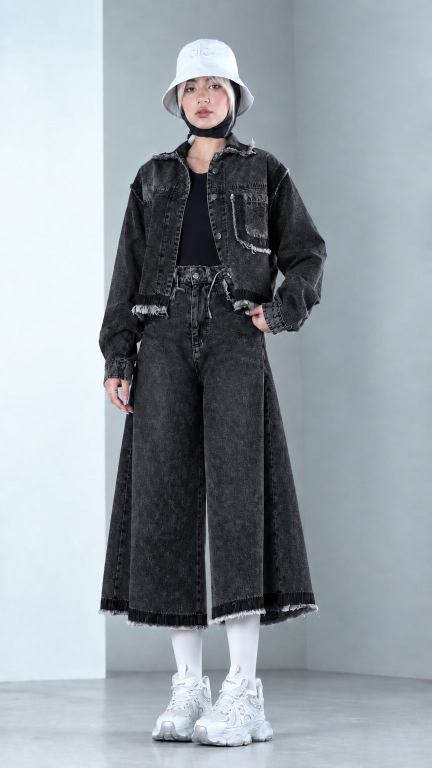 Front view of model wearing Washed Black raw hem denim jacket and culottes set
