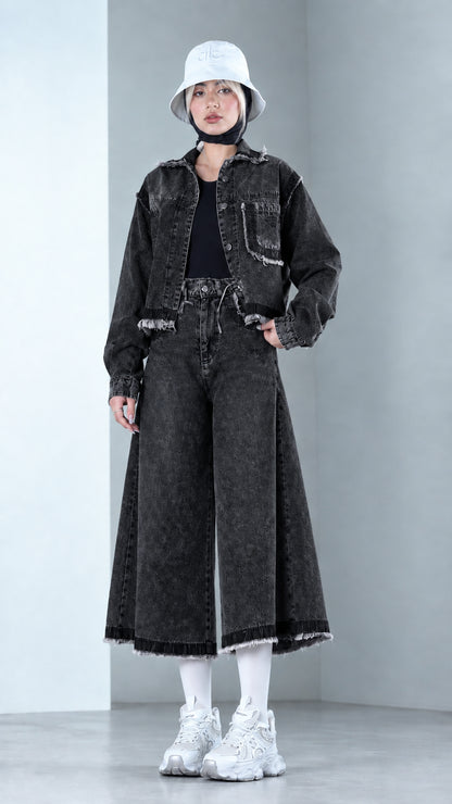Front view of model wearing Washed Black raw hem denim jacket and culottes set