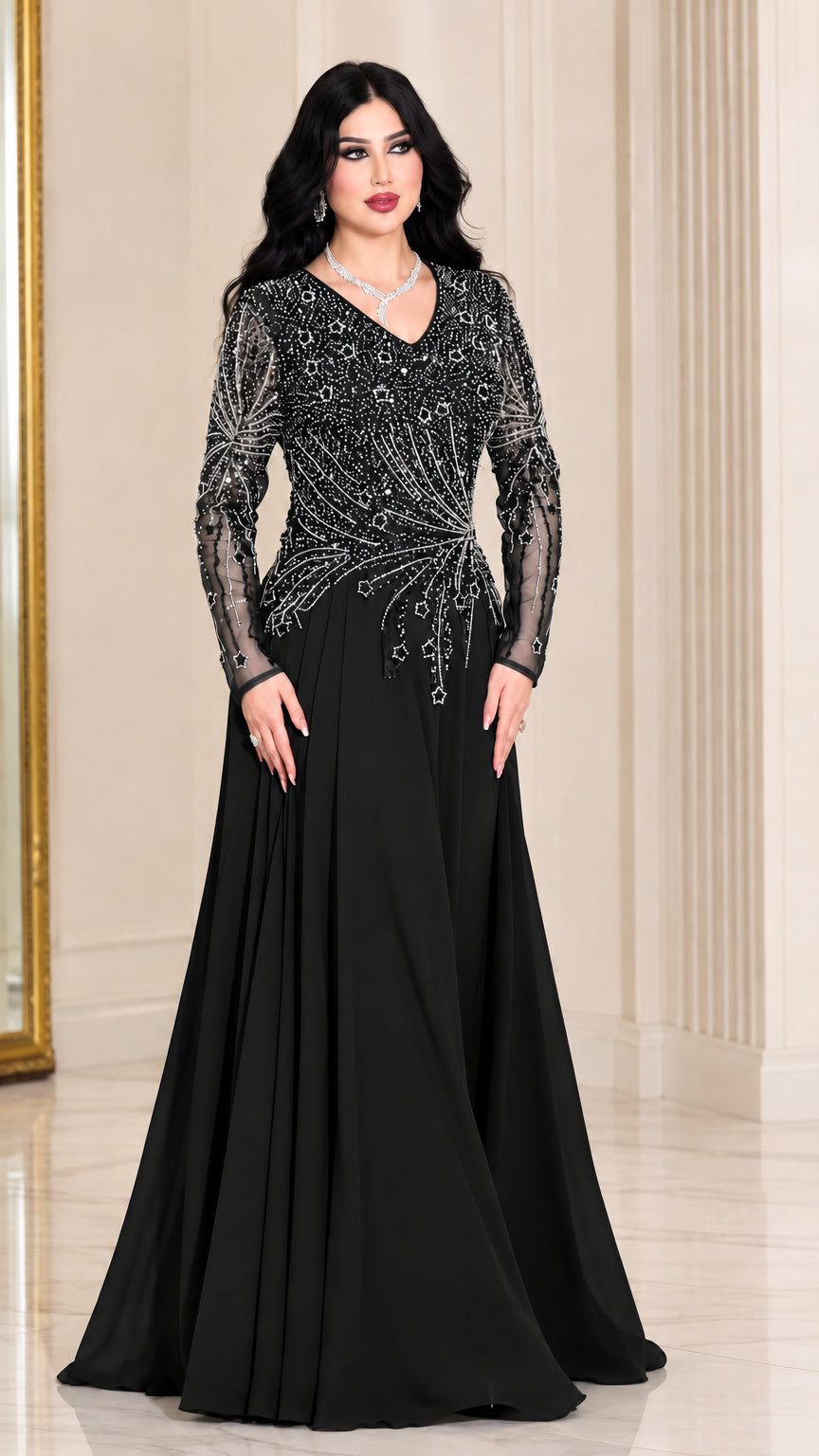 Front view of woman wearing black long sleeve beaded evening gown