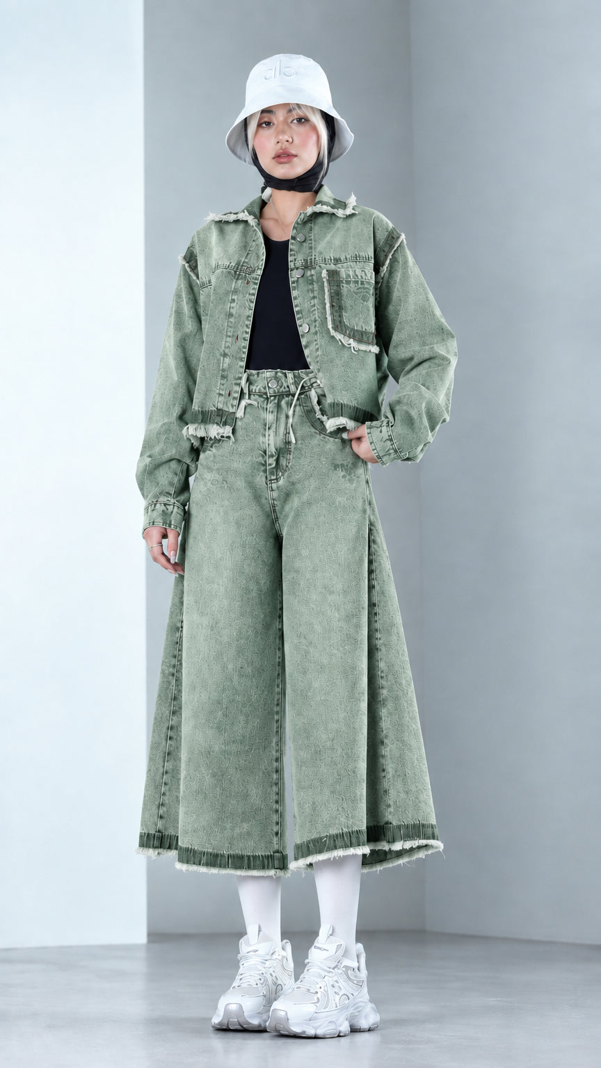 Front view of model wearing Sage Green cropped denim jacket and flared denim pants set