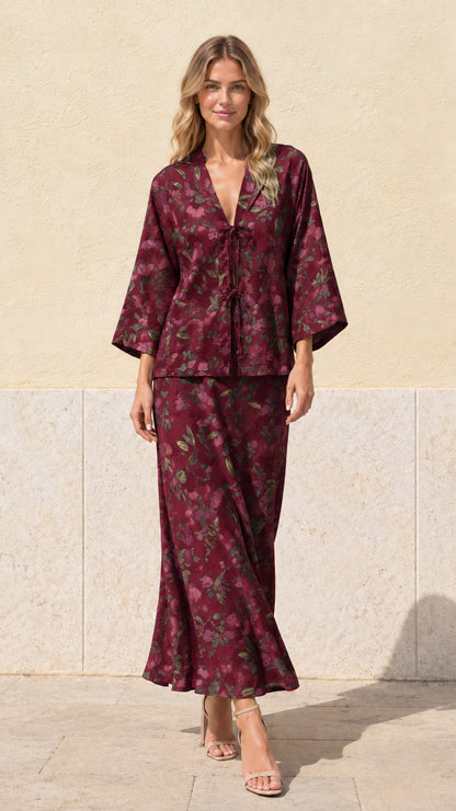 Full front view of model wearing burgundy floral print tie-front top and maxi skirt set