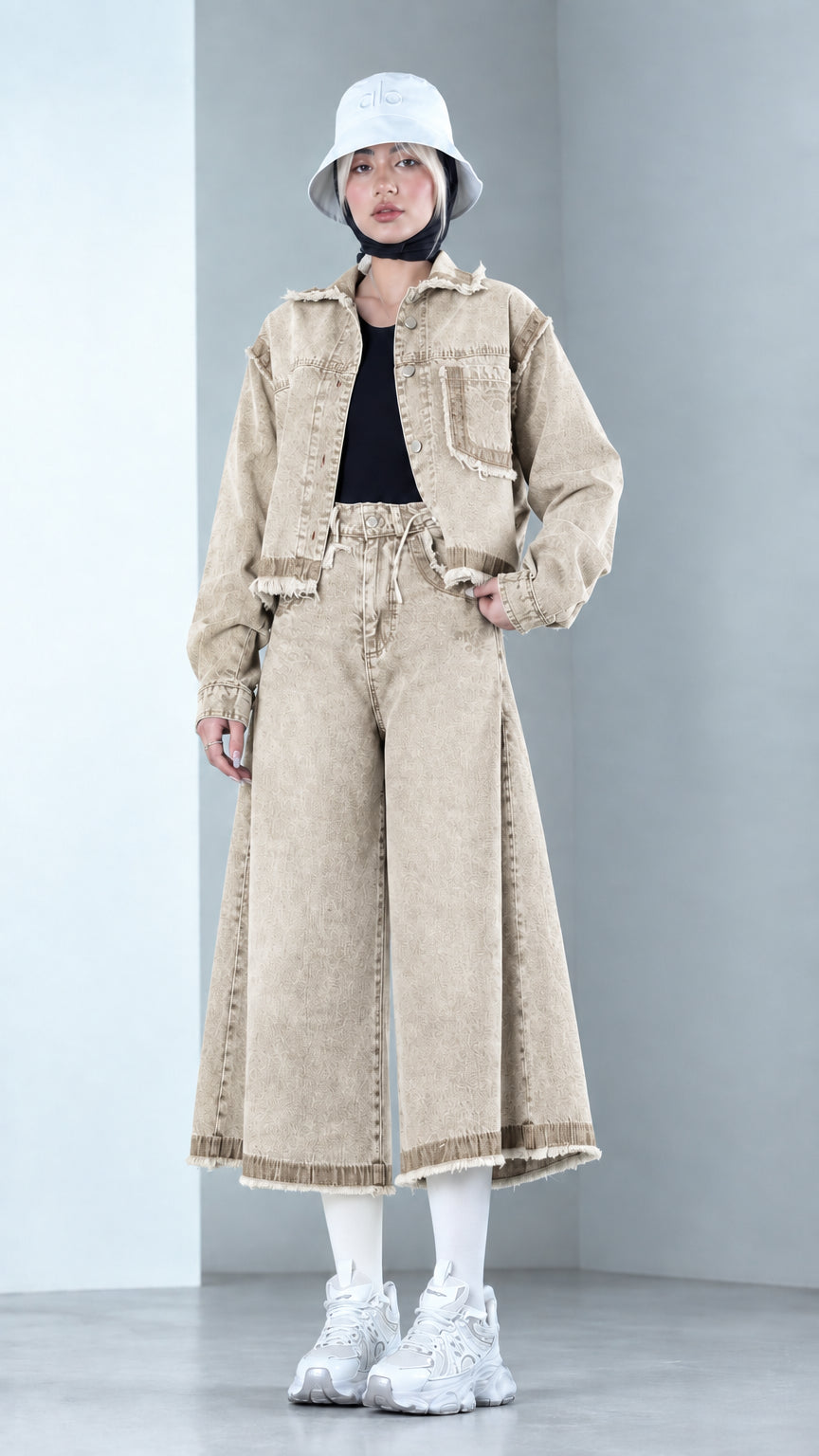 Front view of model wearing Sand Beige two-piece raw hem denim jacket and culottes set