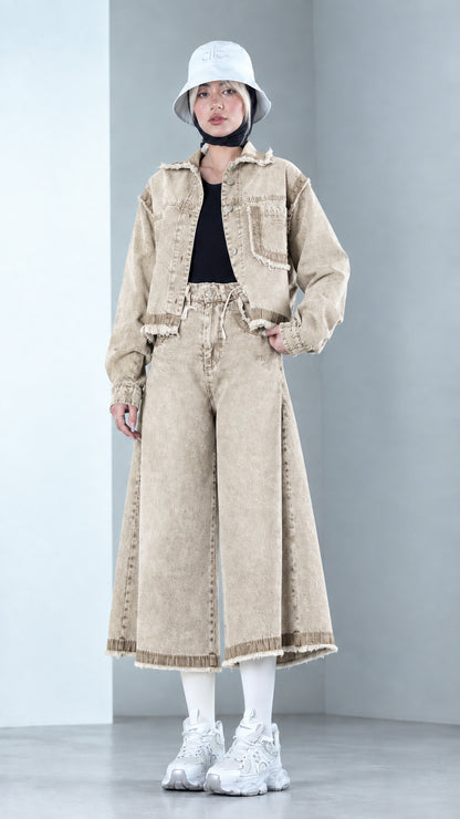 Front view of model wearing Sand Beige two-piece raw hem denim jacket and culottes set