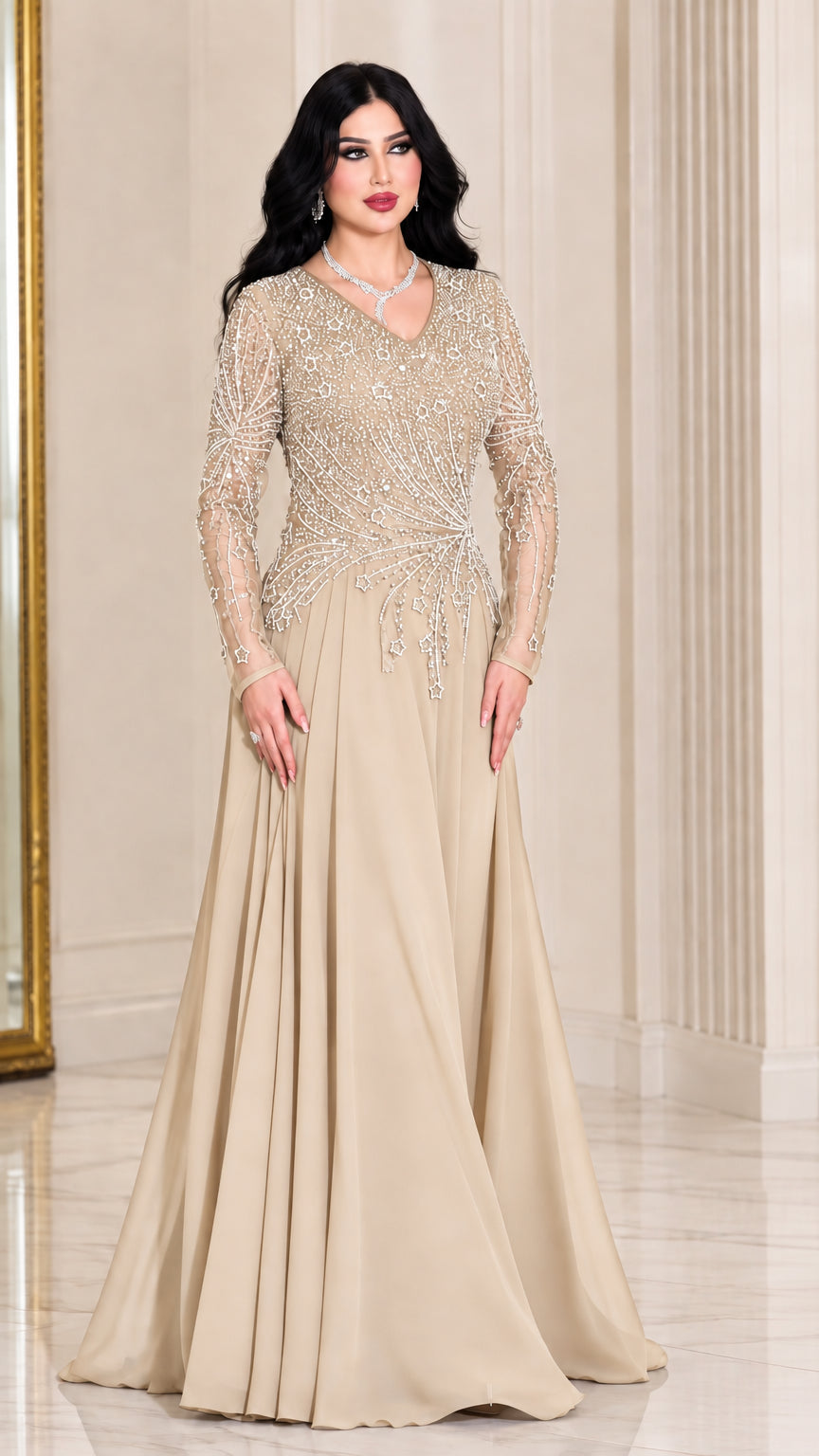 Front view of woman wearing champagne gold long sleeve beaded evening gown